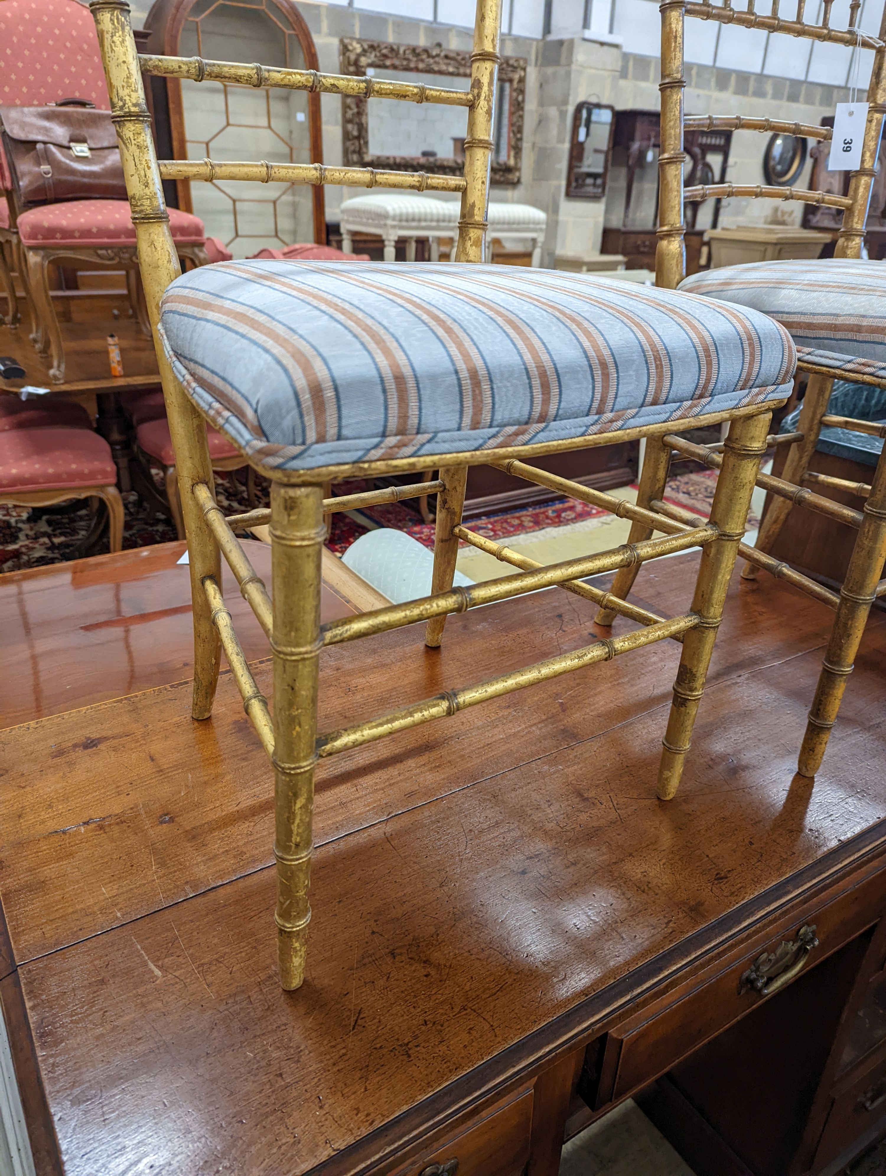 A pair of Regency simulated bamboo gilt wood side chairs with striped seats